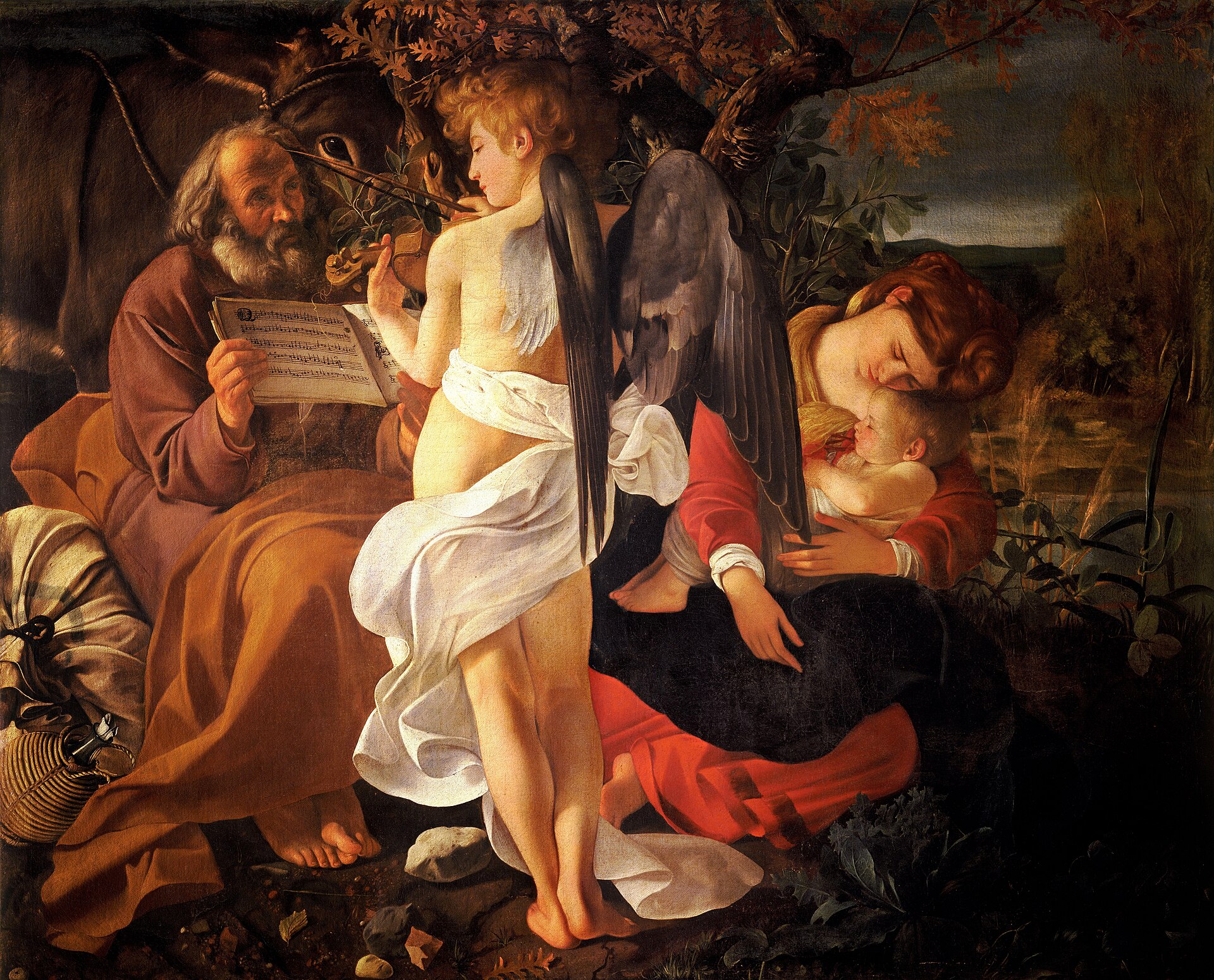 Un ángel de espaldas toca el violín mientras José sostiene la partitura y María duerme con el Niño, en el «Descanso en la huida a Egipto» de Caravaggio.